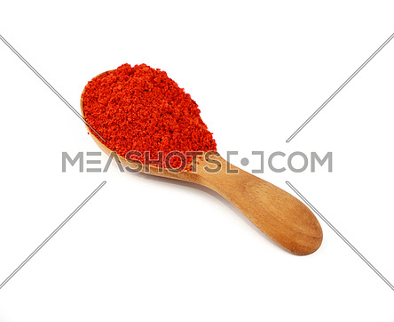 Close up one wooden scoop spoon full of red chili pepper or paprika powder isolated on white background, high angle view