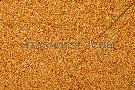 Close up background texture of brown raw cane sugar, elevated top view, directly above