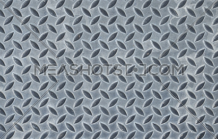 Gray industrial anti slip embossed metal steel plate with diagonal bumps of diamond pattern texture, background, close up