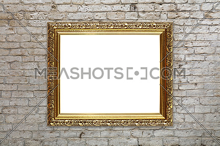 Close up antique old baroque ornate wooden classic golden painted horizontal rectangular frame for picture or photo, over grey brick wall background