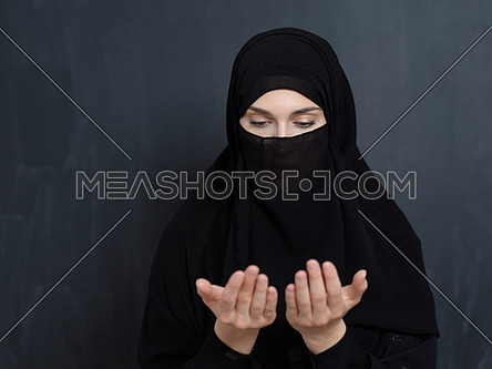 Portrait of young Muslim woman with niqab making dua-259421 | Meashots