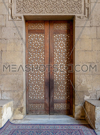 External old arabesque decorated wooden door leading to al Rifai Mosque, Old Cairo, Egypt