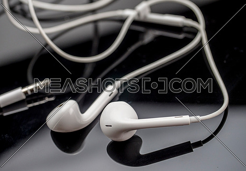White headphones isolated on black background, conceptual image-216691 |  Meashots