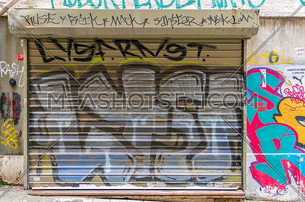 Istanbul, Turkey - April 18, 2017: Closed shop exterior with metal rolling door covered with colorful graffiti near Istiklal Street