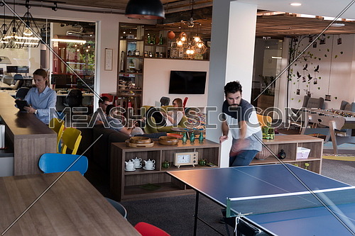 playing ping pong tennis at creative office space-119322 | Meashots