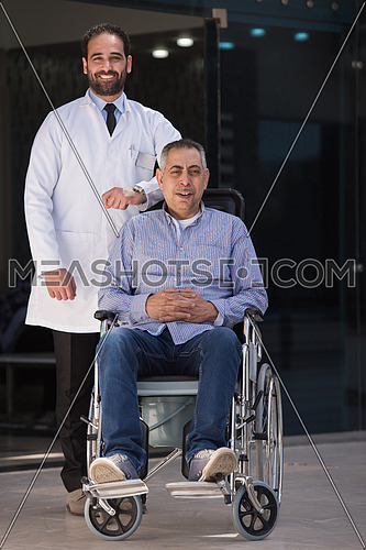 Man In Wheelchair With Young Doctor 118643 Meashots