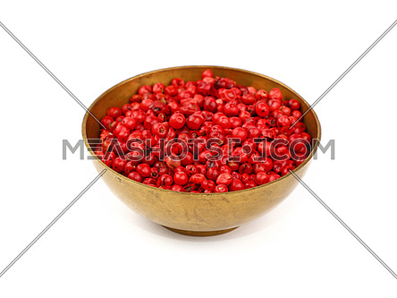 Close up one bronze metal bowl full of red pink pepper peppercorns isolated on white background, high angle view