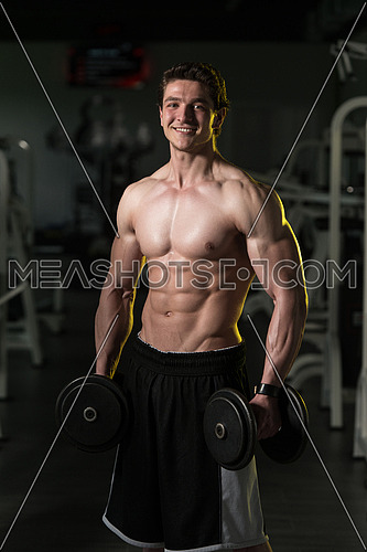 Young Man With Dumbbells Exercising Biceps-99284