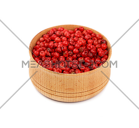 Close up one wooden bowl full of red pink pepper peppercorns isolated on white background, high angle view