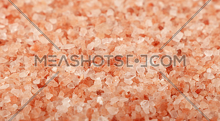Close up background texture of large and medium crystals pink Himalayan salt, high angle view, selective focus