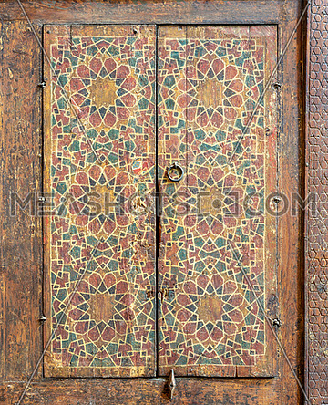 Ornaments of a wooden cupboard painted with colored geometrical patterns embedded in the walls of Sultan al Ghuri Mausoleum, Cairo, Egypt