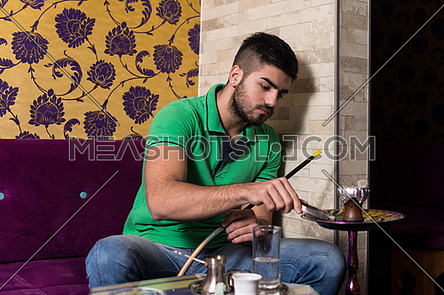 Man Smoking Shisha In The Arabic Cafe-100957 | Meashots