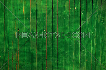 Close up background texture of green uneven painted wooden planks, rustic style fence