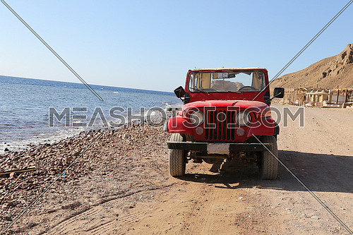 Red Old Jeep stop beside the sea on sandy-201709 | Meashots