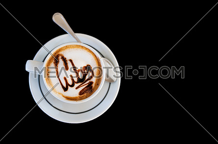 Capuccino on a cup with foam and above the foam the inscription Cuba on a black background