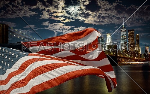 American flag flying the against a dusk sky Brooklyn Bridge and Manhattan, New York City, USA