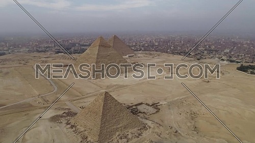 Reveal Shot for The Great Pyramids of Giza in Cairo by day.

