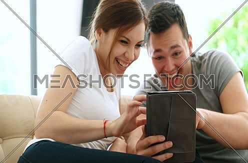 Young Couple using interent on digital tablet