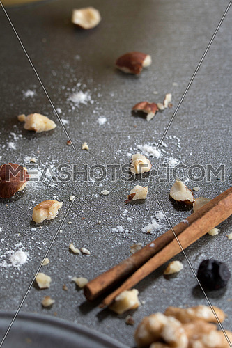Dry nuts crumbs and flour on a grey background
