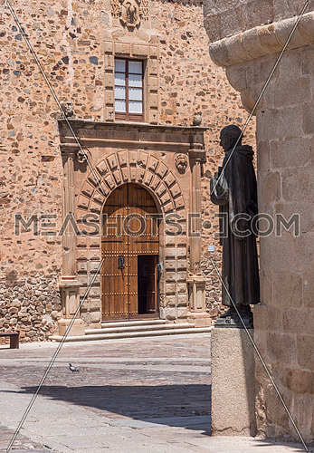 Caceres, Spain - july 13, 2018: Monument to San Pedro de Alcantara, made in 1954, located in the Plaza de Santa Maria, annexed to the church, Caceres, Spain