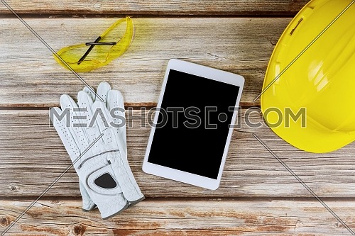 Architecture office construction and architecture in notepad of protective gloves, yellow hard hat