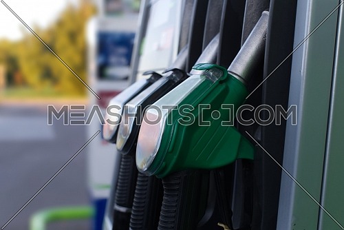 Fuel pumps station in close up with copy space, fuel nozzles at the gas station