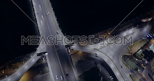 Aerial shot flying around 6 of October Bridge over Abd Elmonan Reyad Bus Station then flying toward the River Nile At Tahrir Area in cairo at night