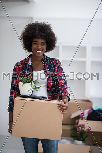 Beautiful African  American girl moving in the new apartment