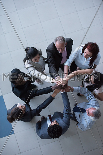 top view of multi ethnic  business people group as team  standing in circle and joining hands