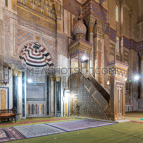 Colorful decorated marble wall with engraved Mihrab - niche - and wooden Minbar - Platform - at public historical Al Rifaii Mosque, aka Royal Mosque, Old Cairo, Egypt