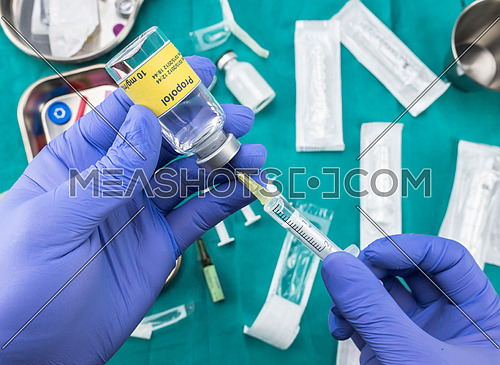 Nurse preparing hospital medication with propofol, conceptual image, horizontal composition