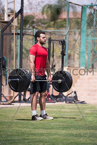 young middle eastern man athlete exercise weightlifting Napoljun on a sunny day