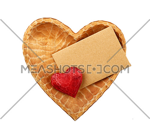 Close up one red painted natural wooden carved heart over brown paper envelope in heart shaped bowl isolated on white background
