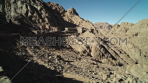 Reveal shot for passage inside Sinai Mountain at day.