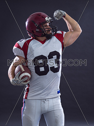 american football player celebrating touchdown isolated on gray background