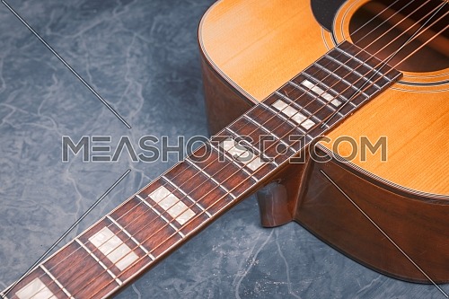 acoustic guitar on blue marble background,music concept.