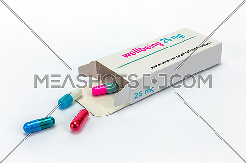 Open medicine packet labelled wellbeing opened at one end to display a blister pack of tablets, isolated on white