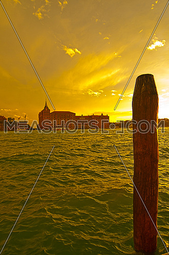 Venice Italy lagune view with "bricole" timber planted to sign the way of the canal