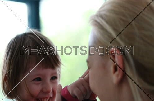 mother playing with kid at modern home
