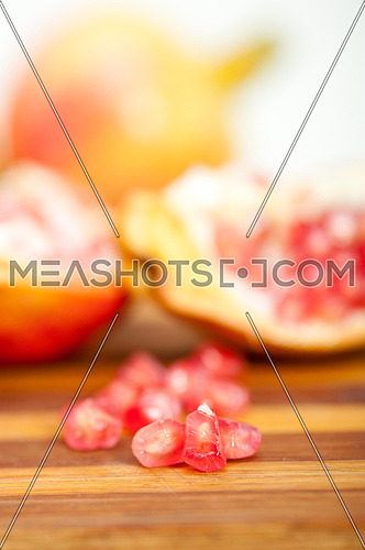 fresh pomegranate fruit over wood cutting board