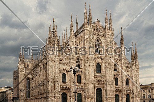 Duomo , Milan gothic cathedral with very cloudy sky ,Italy,Europe.Horizontal photo with copy-space.