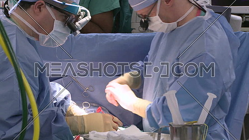 medium shot for two Doctors perform heart surgery
