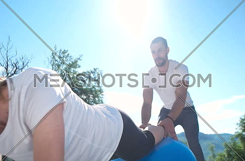 Woman And Man Doing Stretching And Fitness Togetheron terrace of beautiful villa