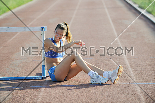 happy young woman on athletic race track relax 