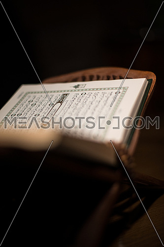 pages of holy koran and rosary at the book