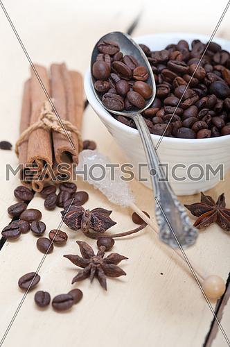  coffe sugar and spice on silver spoon over white wood rustic table 