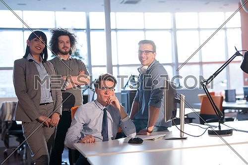 Portrait of young business people discussing business plan  in the office