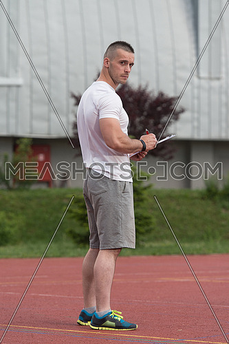 Portrait Of A Male Fitness Instructor Holding Clipboard Outdoor