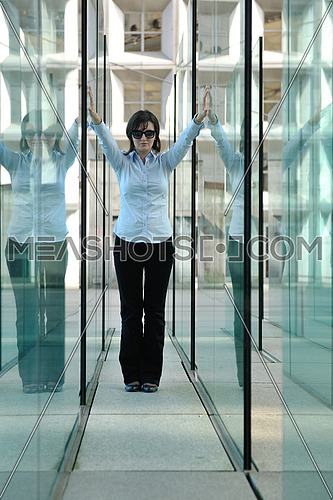 beautiful young woman standing in a modern glass interior building