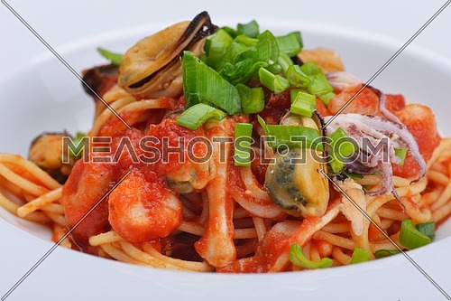 Pasta with shrimps, herbs and mashrooms isolated on white background in studio